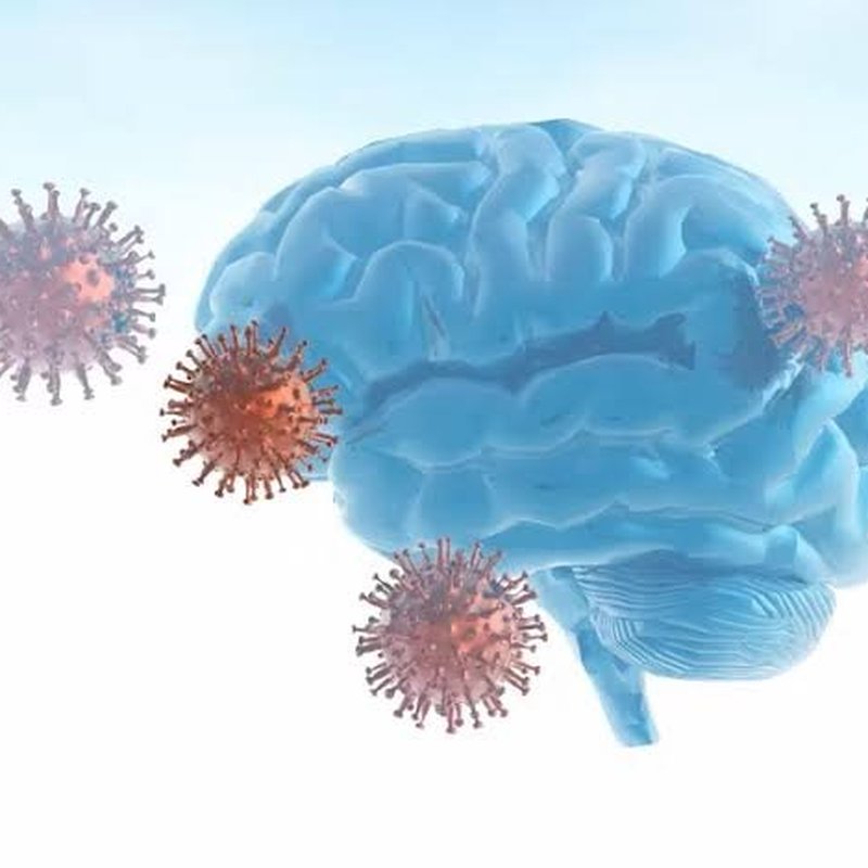 Blue brain model surrounded by virus particles, representing pandemic-related cognitive concerns