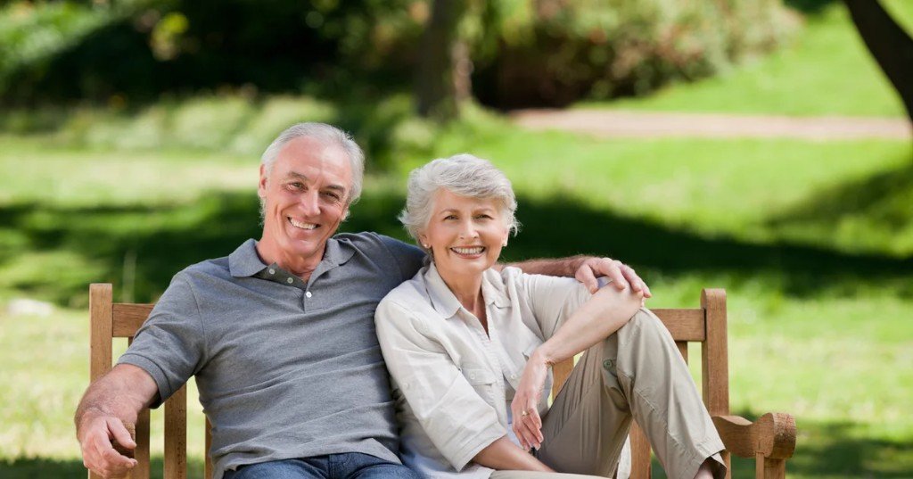Older couple playing chess, representing mental engagement and healthy lifestyle