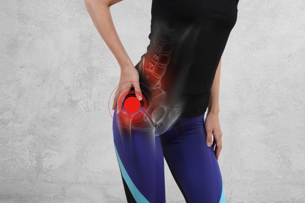 Person with anatomical overlay highlighting hip joint discomfort