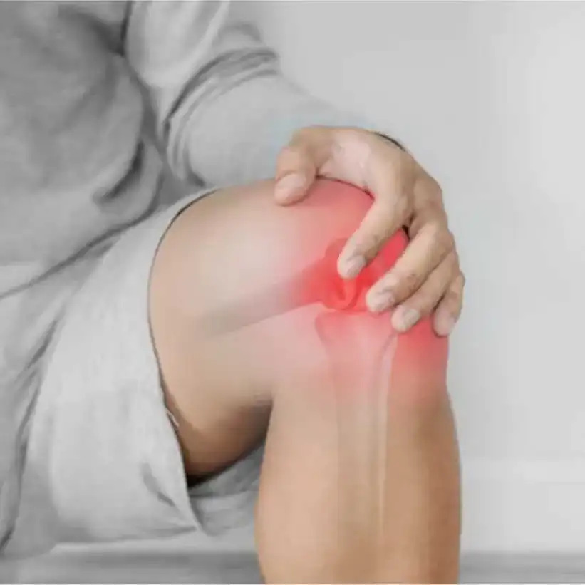 Person holding knee with X-ray style overlay and red glow indicating joint discomfort