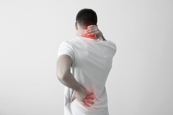 Person holding neck and lower back with red highlights indicating discomfort