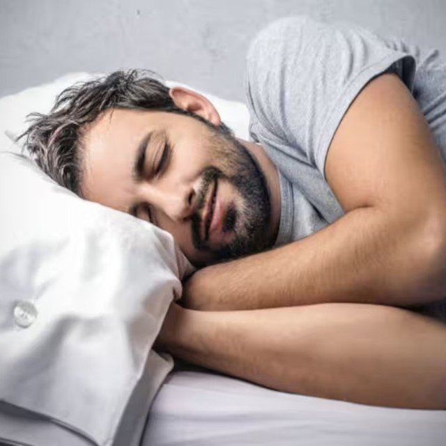 Man sleeping peacefully representing restorative versus non-restorative sleep