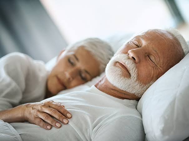 Older couple sleeping peacefully together