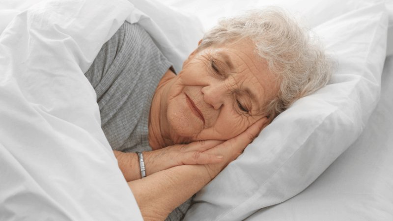 Older woman sleeping peacefully in bed